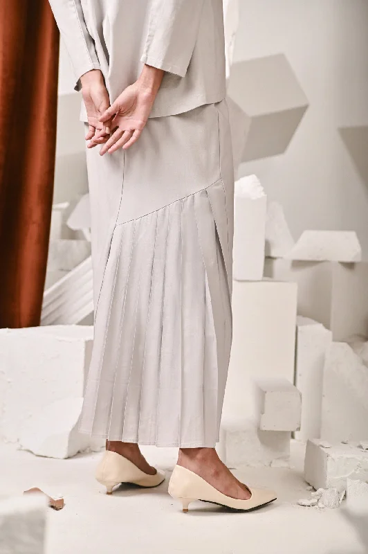 The Kita Menang Women Back Pleats Skirt - Light Grey asymmetrical skirt cut